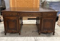 Full front view of desk showing removable top, center drawer and two pedestal cabinets.