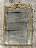 Front view of rectangular gilt mirror showing full frame and mirror surface