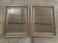 Pair of mirrors placed side by side on floor