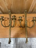 Both sconces side by side against wood backdrop, showing overall pair and matching design