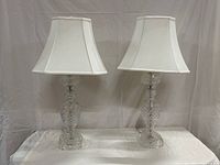 Pair of hand cut lead crystal table lamps with white fabric shades, front view