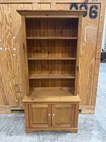 Front view of entire pine cabinet and hutch showing beadboard back and double-door base