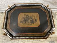 Top-down view of octagonal tray showing pierced gallery rim, decorative red and gold border, and central transferware scene.