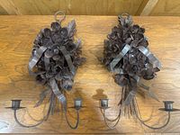 Two sconces side by side on wooden surface showing overall shape and size