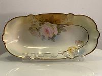 Top view showing floral design and scalloped edges with gold trim.