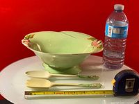 Photo showing the Royal Winton light green hand painted fruit service bowl with 3D details, alongside two matching serving spoons and a water bottle for scale.
