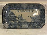 Full view of the rectangular vintage cake plate showing detailed blue and white Asian landscape scene and patterned border.
