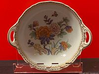 Full view of the vintage Kaiser vegetable bowl showing floral paint design and handles