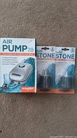 Active Aqua 2 outlet air pump box and two Active Aqua air stones in original packaging.