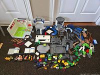 Overview of the multiple Playmobil pieces and sets combined on floor, showing the size and scope of the lot.