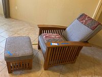 Full side view of Arts & Crafts style adjustable wooden lounge chair with patterned cushions and matching ottoman with light gray cushion.