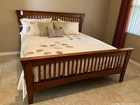 Front view of Arts & Crafts style king bed with headboard, footboard, bedding and pillows