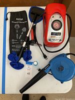 Photo showing Black & Decker Air Station, TruePower blower, and AstroAI windshield cleaning kit with tools and accessories.
