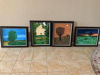 Four original paintings in matching dark frames displayed against a beige wall and tiled floor.