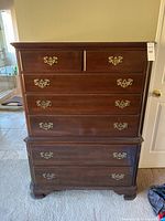 Front view of full dresser showing overall shape, finish, drawer arrangement