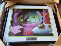 Framed print showing Duck Dodgers on an alien planet with rocket ship, with silver plaque reading 'Duck Dodgers in the 24 1/2th Century'.