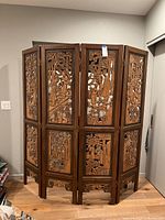 Frontal view of four-panel carved wooden screen