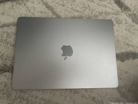 Closed laptop top view showing space grey aluminum lid and Apple logo