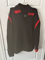 Full front view of the black and red Armani Exchange sweater showing red stripes on the collar and sleeves.