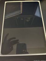 Front view of Apple iPad 9 showing the screen and home button.