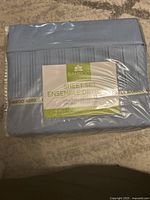 Photo of the Live Well Bamboo 4000 sheet set packaging showing light blue fabric and product label.