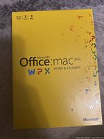 Front of the yellow Microsoft Office Mac 2011 Home and Student family pack box showing product title and colorful WPX logo letters