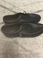 Top view of the Polo Ralph Lauren black leather shoes showing the pony logo on the side and overall condition.