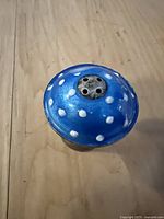 Top view of blue enamel mushroom cap with white polka dots