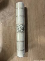 Roll of off-white mesh ribbon with gold horizontal stripes, labeled 'B Mesh'