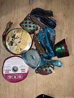Photo of assorted designer ribbons in various colors and textures on a wooden floor