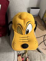 Alternate front view of the same yellow Goofy character hat to depict details and condition from a slightly different angle.