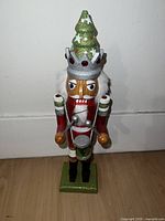 Front view of nutcracker showing detailed face, drum, fur collar and hat.
