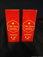 Photo showing two red sealed boxes of Old Spice Classic cologne, each 125 ml.