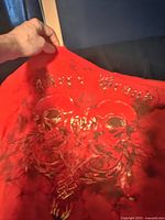 Photo showing red graphic on front of Avirex t-shirt with skull and floral design