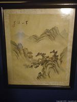 Framed signed Chinese watercolor or ink landscape painting with mountains, pine trees, and a pavilion, signed with calligraphy and artist seals.