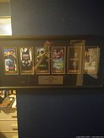 Full view of framed memorabilia with six movie tickets inside.