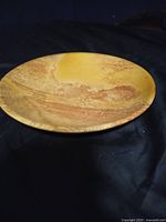 Top view of large round marble bowl showing natural earth tone patterns and smooth surface.