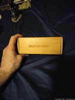 Bamboo case engraved with 'MADE-BY-HAND' shown closed