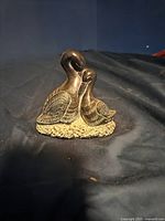 Front view of the soapstone sculpture showing two birds on a textured base.