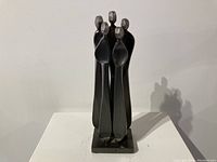 Front view of the Boris Kramer abstract metal sculpture showing five stylized human figures on base.