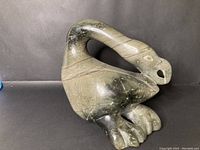 Front right three-quarter view of carving showing overall form and polished finish