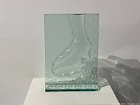 Front and side view of the clear textured art glass vase with unique wavy design showing its form and texture.