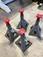 Four Larin brand 2 ton jack stands positioned on concrete floor, showing their overall shape and color.