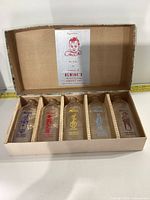 Five vintage Alwine's baby milk bottles in original cardboard box with compartments.