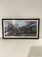 Front view of the framed print showing two steam locomotives on tracks under a cloudy sky.