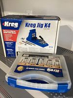 Box for Kreg Jig K4 and plastic case for Kreg Pocket-Hole Screw Kit shown together.