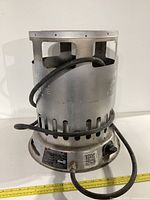 Front angle view of propane construction heater with hose coiled around handle