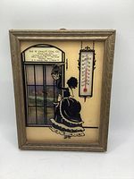 Front view of framed thermometer showing design and temperature scale