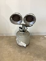 Full view of the tank top propane heater showing cylindrical propane tank and dual burner heater with protective grills.