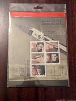 Front view of sealed plastic sleeve containing commemorative Canadian aviation stamp set mounted on display card featuring Avro CF-105 Arrow technical drawings and aircraft image